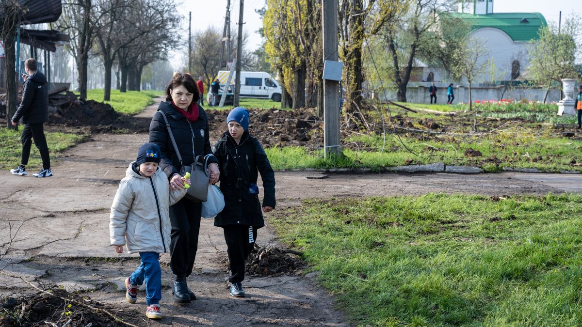 KRAMATORSK, UKRAINE - APRIL 24: A Ukrainian woman walks with two children near an impact crater after two Russian rockets struck overnight beside a school in Kramatorsk, Ukraine, on April 24, 2023. While fighting has continued to rage across the Donbas region, and a Ukrainian spring counteroffensive is expected at any time, Russian forces have fired rockets at residential areas in cities miles back from the frontline, and across Ukraine. (Photo by Scott Peterson/Getty Images)