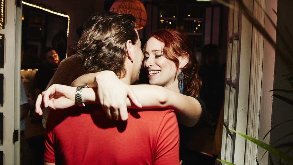 Smiling woman embracing boyfriend during party in night clubThomas Barwick