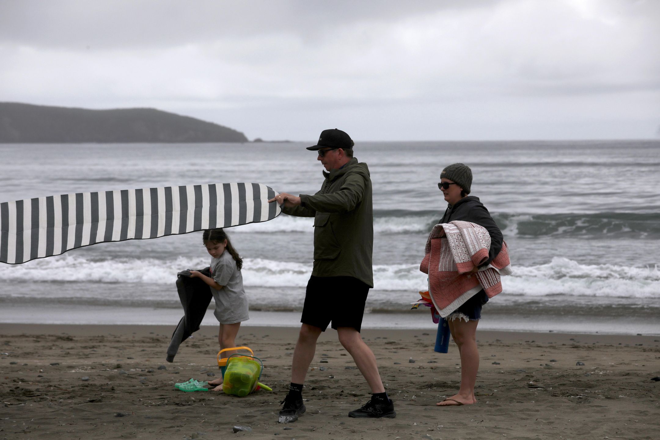 DILLON BEACH, CA - APRIL 24, 2024 - Nevada City residents Cameron E., 39, his wife Jessica, 42, and daughter Jo, 8, get ready to spend the day at Dillon Beach on April 24, 2024. The family are renting a house in Dillon Beach.  Dillon Beach has allowed more rentals than other area in West Marin County.
West Marin County, home to some of California's most beautiful beaches and most expensive homes, is putting a cap on short-term rentals. Proponents of the cap say Airbnbs have ruined small towns, eating valuable housing stock and making it devoid of actual locals. Opponents say it's so expensive anyway that a vacation rental ban doesn't add affordable housing. This had to go before the California Coastal Commission who proposed regulations would maintain visitor access to the coast while preventing the further erosion of West Marin's year-round supply of rental housing. (Genaro Molina/Los Angeles Times via Getty Images)