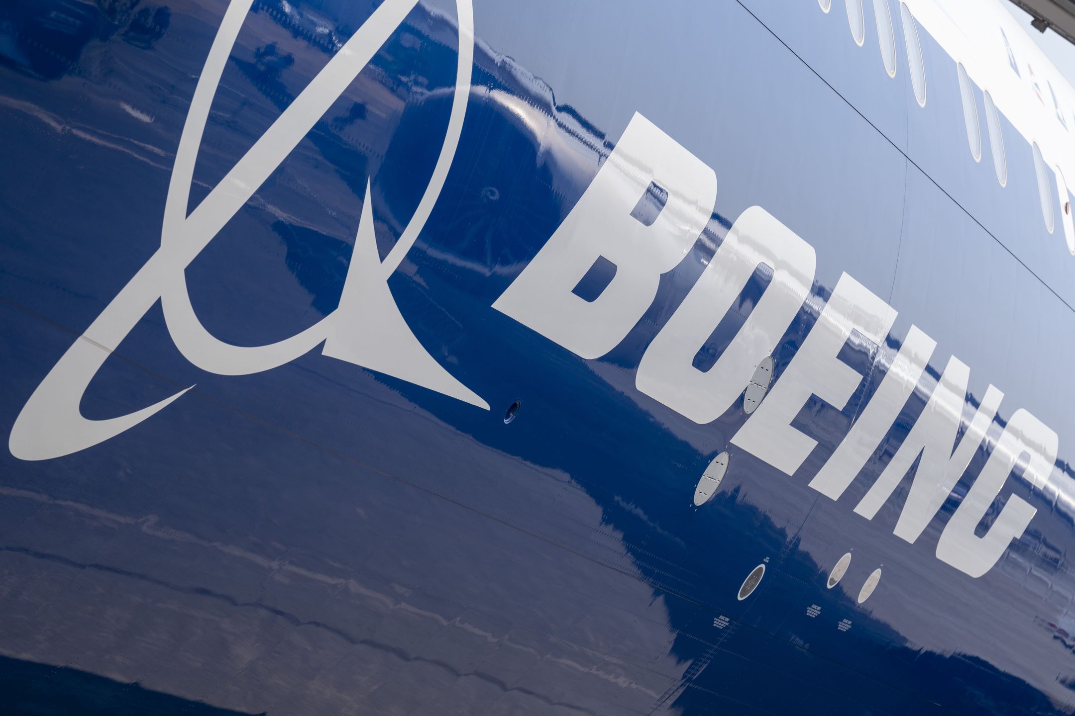 The Boeing logo on the fuselage of a 777X jet airliner at the Farnborough Airshow, on 18th July 2022, at Farnborough, England. The US aviation manufacturer is recovering from a financial downturn following the series of 737 Max crashes. The Farnborough International Airshow (FIA) is an aerospace and defence industry trade fair which, due to Covid, is being held for the first time in four years. The pandemic has had a major impact on commercial aviation, while the war in Ukraine has changed the mindset for defence industries. There are 1,200 exhibitors from 42 countries here with organisers hoping to attract more than 80,000 visitors over the week. (Photo by Richard Baker / In Pictures via Getty Images)