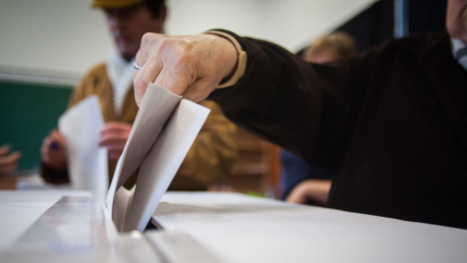 A person casts her ballot during voting for parliamentary elections at a polling station in Bucharest, Romania.
elect, election, document, voting, vote, envelope, slot, inserting, voter, hand, politics, democracy, decision, referendum, box, paper, ballot, political, candidate, choose, choice, casting, arm, hold, put, place, polling, insert, bulletin, person, option, people, citizen, poll, democratic