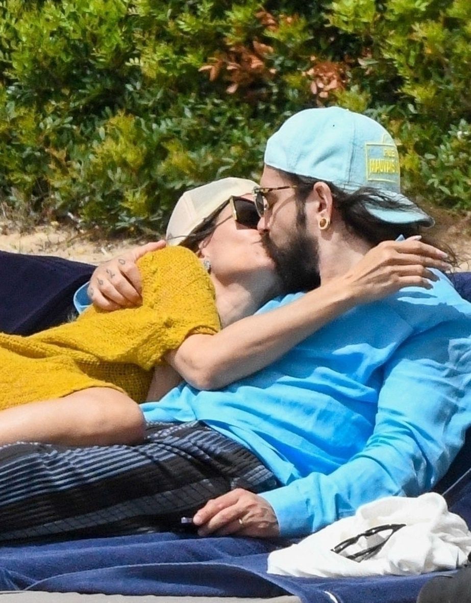 *PREMIUM-EXCLUSIVE* MUST CALL FOR PRICING BEFORE USAGE  - Love is All Around for Heidi Klum and her husband Tom Kaulitz as they set the temperatures soaring along with Heidi's daughter Leni and her boyfriend Aris Rachevsky during their sizzling hot family
*PREMIUM-EXCLUSIVE* Sardinia, ITALY  - MUST CALL FOR PRICING BEFORE USAGE  - Heidi Klum and her husband Tom Kaulitz turn up the temperatures out on their sun-soaked holiday out in Sardinia.

51-year old Heidi, the German-American model and television host looked stunning in her skimpy little bikini set as she took in the rays, slapping on the sun cream.

Heidi and Tom showed off their undying love for one another, packing on the PDA with a few kisses sprawled out on their sun beds on their family trip.

Accompanying the loved up couple was Heidi's daughter Leni Klum showing off her svelte figure in the hot Sardinian sunshine seen with her boyfriend Aris Rachevsky along with the kids, Johan and Henry.

It would seem love is in the air also for Leni as she too packed on the PDA with a rather hot display out on the beach with a few hugs and kisses as Aris took a few snaps of his girl during the European family getaway.

*Pictures Containing Children Please Pixelate Face Prior To Publication*,Image: 883521781, License: Rights-managed, Restrictions: RIGHTS: WORLDWIDE EXCEPT IN ARGENTINA, AUSTRIA, FRANCE, GERMANY, ITALY, MEXICO, PORTUGAL, SPAIN, SWITZERLAND, Model Release: no, Pictured: Heidi Klum, Credit line: COBRA TEAM - FREZZA LAFATA / BACKGRID / Backgrid UK / Forum
COBRA TEAM - FREZZA LAFATA / BACKGRID / Backgrid UK / Forum
Heidi Klum, Tom Kaulitz, daughter, holiday, beach, vacation, sunbathing, mum, mother, relaxing, Leni Olumi Klum, boyfriend, PDA, oversized sunglasses, happy, laughing, bikini, cleavage, floral bikini, flower print bikini, heart gold necklace, shopping, thong bikini, kiss, kissing, topless, braless, green beach dress, kaftan dress, see through, cap, tote bag, beach bag, shorts, black vest, jewellery, family holiday, green dress, yellow dress