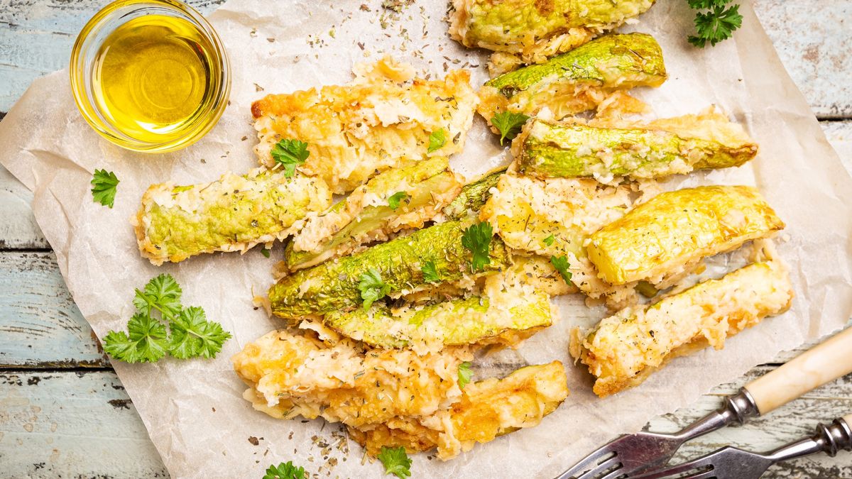 Zucchini sticks in batterZucchini sticks in batter, baked in oven over wooden background, top viewRoxiller