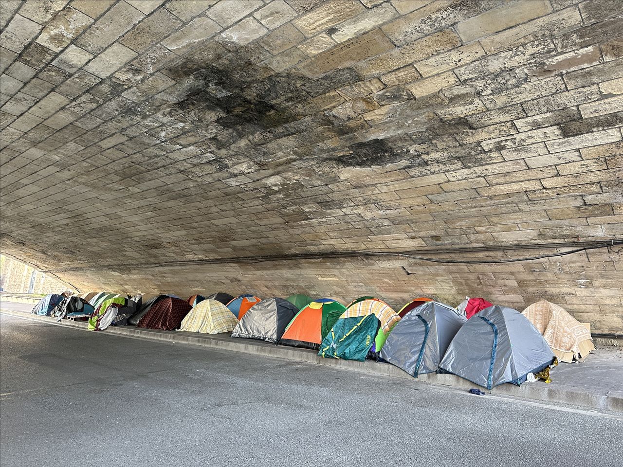 A tent city of the homeless under the bridge on the Seine in Paris