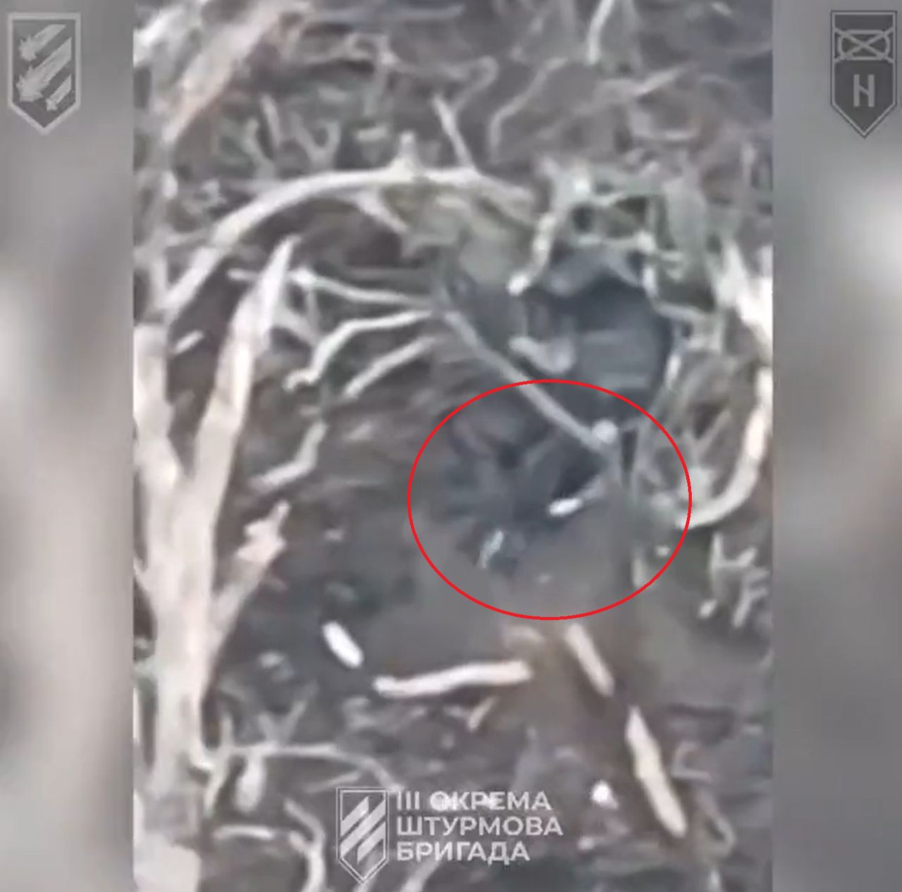 A Russian soldier is throwing a damaged Ukrainian improvised "kamikaze" drone.