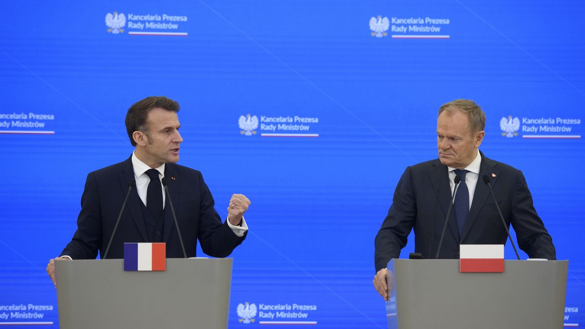 French President Emmanuel Macron (L) gestures as he speaks during a press conference with Polish Prime Minister Donald Tusk (R) after talks in Warsaw, Poland, December 12, 2024.