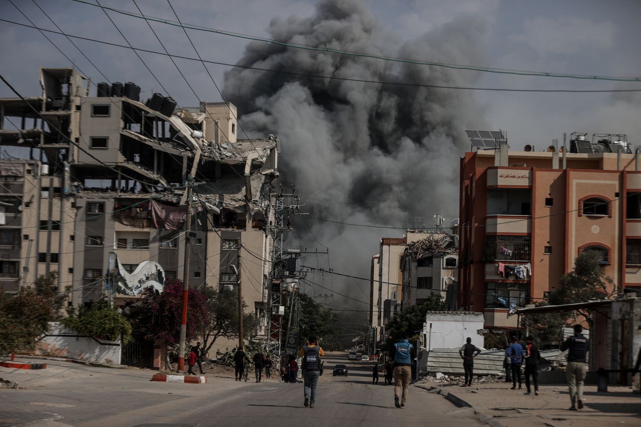 Palestinians flee from the explosion.