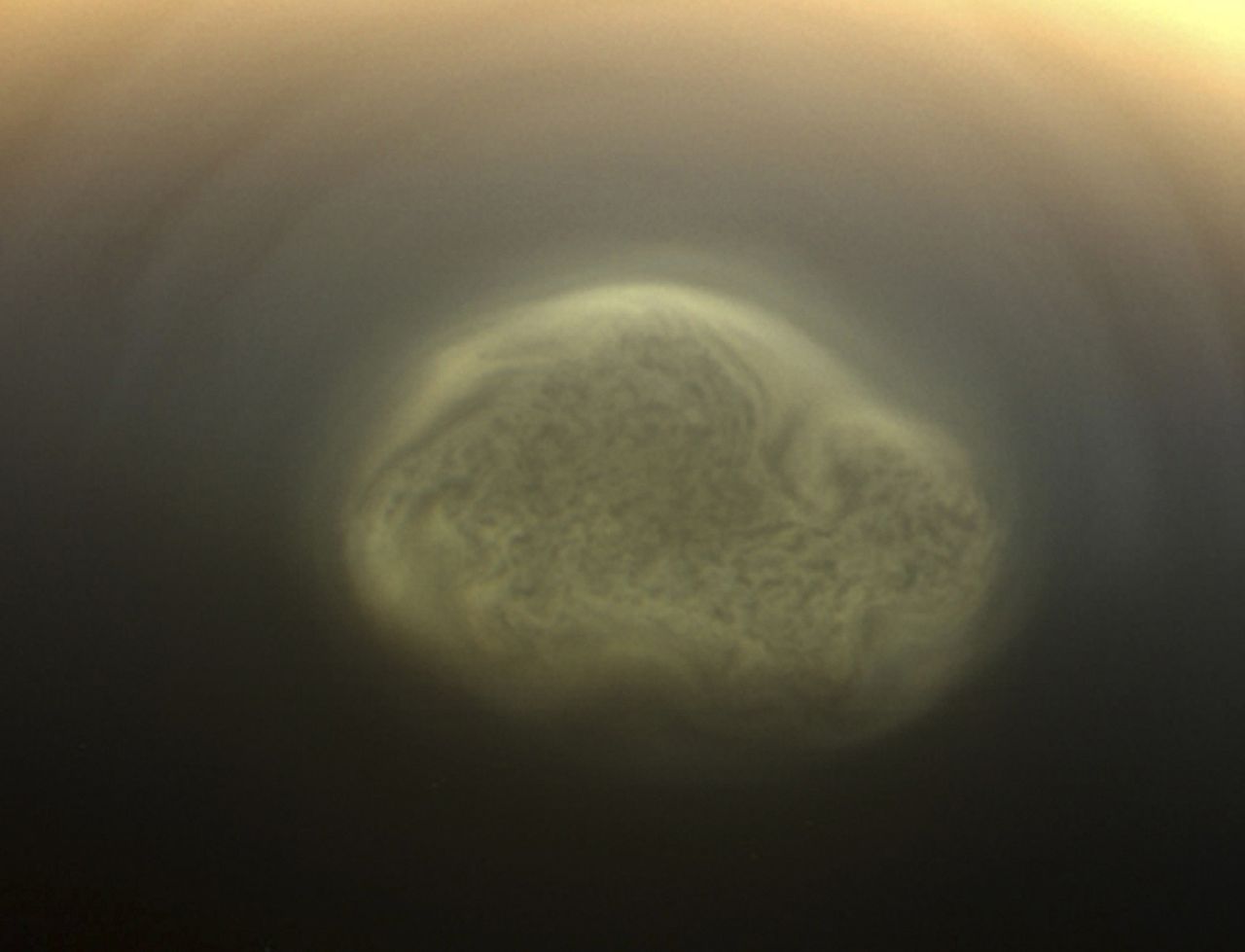 Prawdziwy kolor południowego wiru polarnego na Tytanie z dnia 27 lipca 2012 roku. Wir ten jest zbiorowiskiem gazów w atmosferze księżyca. Miał on około 5 tysięcy kilometrów średnicy. Wir może być powiązany z nadejściem zimy polarnej.