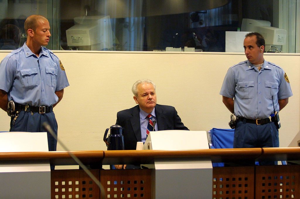 Milosevic Status Hearing in The Hague393856 04: Former Yugoslav strongman Slobodan Milosevic appears for the second time before the Yugoslav war crimes tribunal August 30, 2001 in The Hague, the Netherlands. Milosevic, not represented by a lawyer, expressed surprise that the charges were still not yet presented by the court after 2.5 years. Judge May has appointed a lawyer to represent him in when his October 29 trial begins in which Milosevic will also be charged with war crimes in Bosnia and Croatia. (Photo by Michel Porro/Getty Images)Michel Porrobalkans war crimes, MILOSEVIC, NETHERLANDS, SLOBODAN, STATUS CONFERENCE, table, guards, THE HAGUE, YUGOSLAV TRIBUNAL