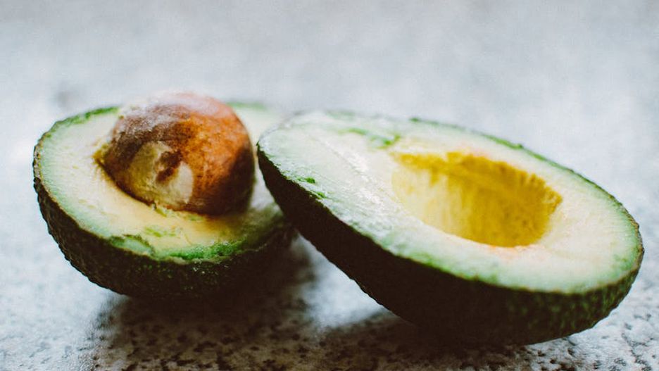 Close-up of a halved avocado, showcasing its rich texture and vibrant green color.