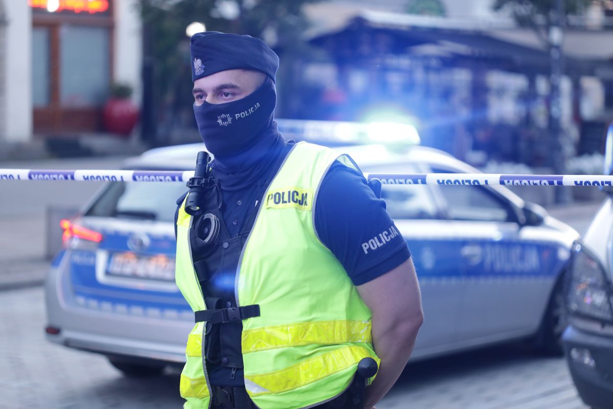 Warszawa, 11.07.2022. Policjant zabezpiecza ewakuowany teren Krakowskiego Przedmieścia w Warszawie, 11 bm. Policja ewakuowała uczestników zgromadzenia i osoby przebywające w promieniu 200 metrów od budynku przy Krakowskim Przedmieściu 64. Mężczyzna wyjął z plecaka i położył na ziemi niebezpieczny przedmiot. Policyjni antyterroryści zabezpieczyli pocisk o dużej sile rażenia. (sko) PAP/Albert Zawada