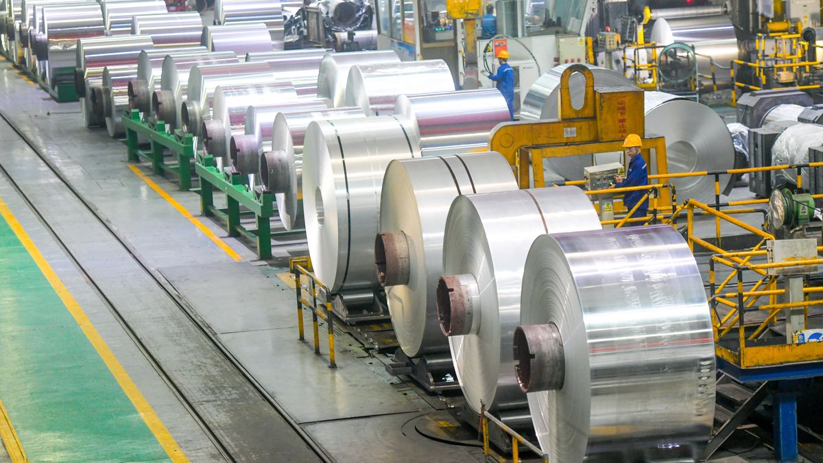 LUOYANG, CHINA - JULY 08: Employees manufacture aluminum foils for export at the workshop of Luoyang Longding Aluminum Industries Co., Ltd. on July 8, 2024 in Luoyang, Henan Province of China. (Photo by Zhang Yixi/VCG via Getty Images)