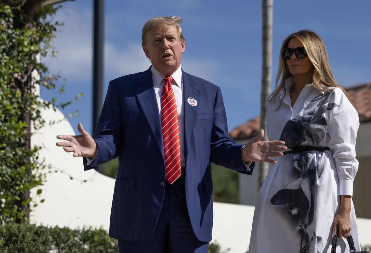 PALM BEACH, FLORIDA - MARCH 19:  Former U.S. President Donald Trump and former first lady Melania Trump stand together as they speak with the media after voting at a polling station setup in the Morton and Barbara Mandel Recreation Center on March 19, 2024, in Palm Beach, Florida.  Trump, along with other registered Republican voters, cast ballots in the Presidential Preference Primary. There wasn't a ballot or election for Democrats since the Florida Democratic Party only provided the name of Joseph R. Biden Jr. (Photo by Joe Raedle/Getty Images)