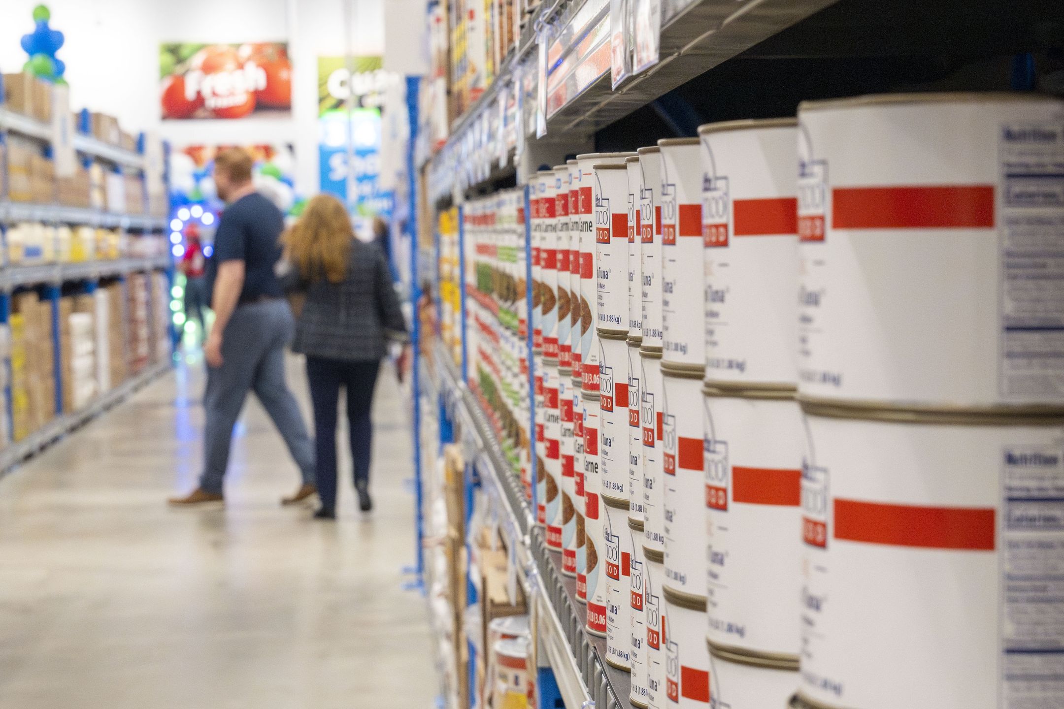 HOUSTON, TEXAS - MAY 7: Customers walk down the aisle as a variety bulk sized canned meats are seen on the shelves at the new Sysco To Go A Restaurant Club location on Katy Freeway in Houston, Wednesday, May 7, 2025. (Kirk Sides/Houston Chronicle via Getty Images)