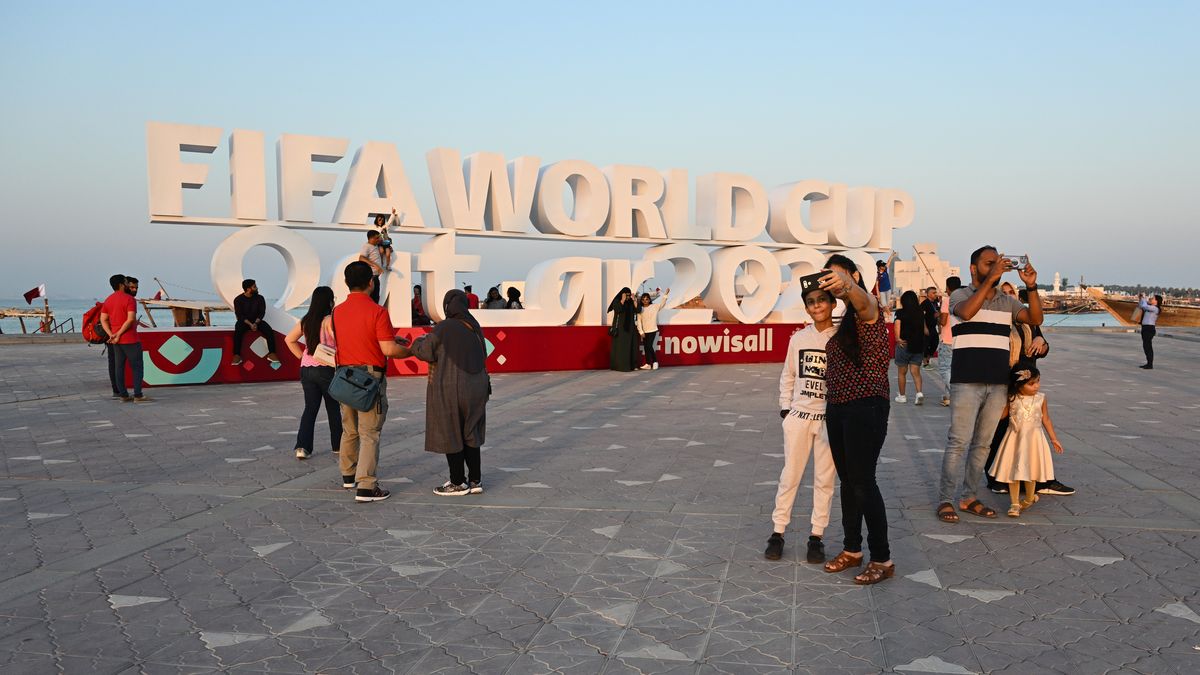 People take selfies with 2022 FIFA World Cup signage  on the Corniche in Doha, Qatar on 29 October 2022.  (Photo by Simon Holmes/NurPhoto via Getty Images)