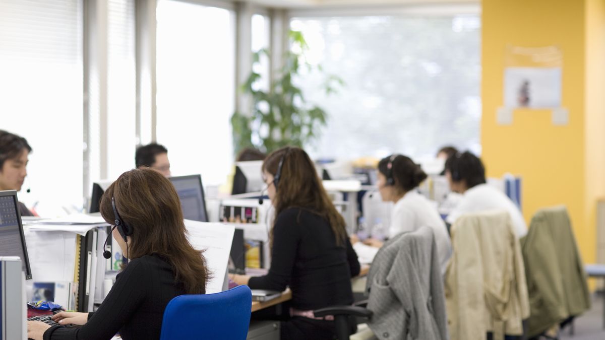 Office workers working in officeMichael HAdnet, Medium Group Of People, Adults Only, Men, Women, Mid Adult Women, 30-34 Years, Indoors, Day, Horizontal, Color Image, Photography, Head And Shoulders, Waist Up, Focus On Foreground, Casual Clothing, Mid-Length Hair, Brown Hair, Sitting, Working, Using Computer, On The Phone, In A Row, Office Worker, Office, Office Chair, PC, Headset, Call Centre, Business, Teamwork, Organisation, Communication, Technology, Concentration