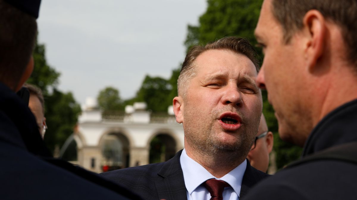 PiS MP and former Minister of Education, Przemyslaw Czarnek, is attempting to destroy a wreath laid at the Monument to the Victims of the Smolensk Tragedy in Warsaw, Poland, on May 10, 2024. In the month of the Smolensk disaster anniversary, which resulted in the deaths of 96 people, including Polish President Lech Kaczynski and his wife, Jaroslaw Kaczynski, along with leading PiS MPs, is celebrating a ceremony at the monument. Every month, a group of people lays a wreath in memory of all the victims and blames President Lech Kaczynski for the plane crash. Former Prime Minister Jaroslaw Kaczynski has destroyed the wreath several times, but this time he is not succeeding. (Photo by Klaudia Radecka/NurPhoto via Getty Images)