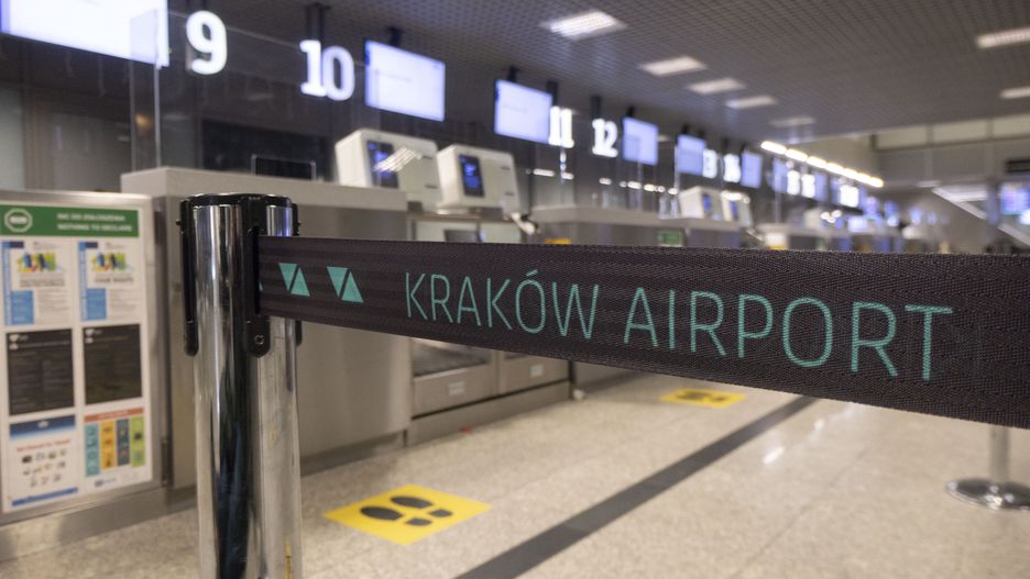KRAKOW AIRPORT logo inscription on a belt strap passenger divider. Kraków John Paul II International Airport KRK known as Krakow Balice airport. Check-in desks, arrival and departure hall and the gates area of the Polish airport terminal. It is the second largest airport in terms of passenger traffic in Poland. The aviation industry and passenger traffic volume are phasing a difficult period with the Covid-19 coronavirus pandemic having a negative impact on the travel business industry with fears of a deteriorating situation due to the new variant mutation like Omicron at the fifth wave. Krakow, Poland on March 18, 2022 (Photo by Nicolas Economou/NurPhoto via Getty Images)