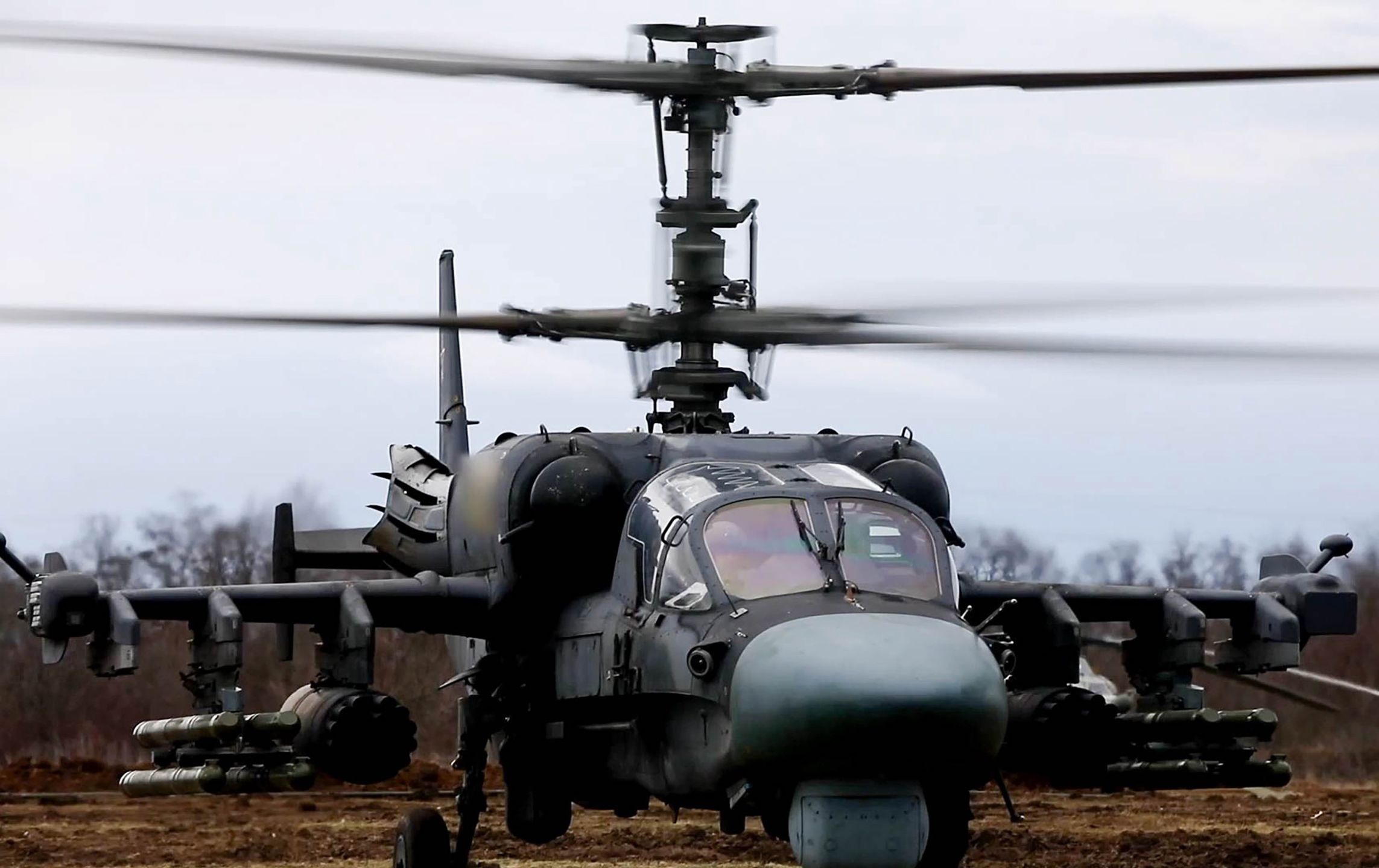 UKRAINE - APRIL 23, 2022: Kamov Ka-52 helicopters of the Russian Aerospace Forces have carried out missile strikes at undisclosed armored military hardware and camouflaged positions of the Armed Forces of Ukraine, destroying a tank, an infantry fighting vehicle, and a strong point. Video screen grab. Best quality available. Russian Defence Ministry/TASS