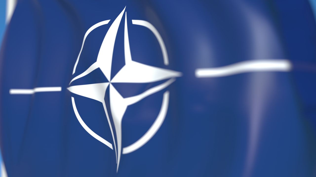 Waving flag with NATO logo
