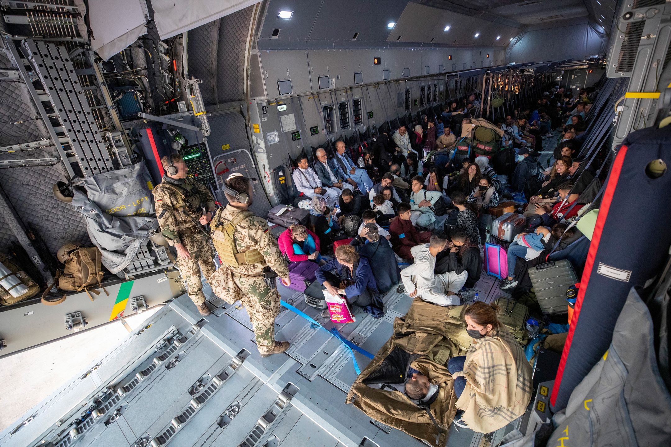 German Forces Evacuate Civilians From AfghanistanTASHKENT, UZBEKISTAN - AUGUST 17: In this handout image provided by the Bundeswehr,  evacuees from Kabul sit inside a military aircraft as they arrive at Tashkent Airport on August 17, 2021 in Tashkent, Uzbekistan. One of three German military planes evacuated some 131 people from Kabul airport to the Uzbek capital of Tashkent before reaching their final destination in Germany.  (Photo by Marc Tessensohn/Bundeswehr via Getty Images)Handoutbestof, topix
