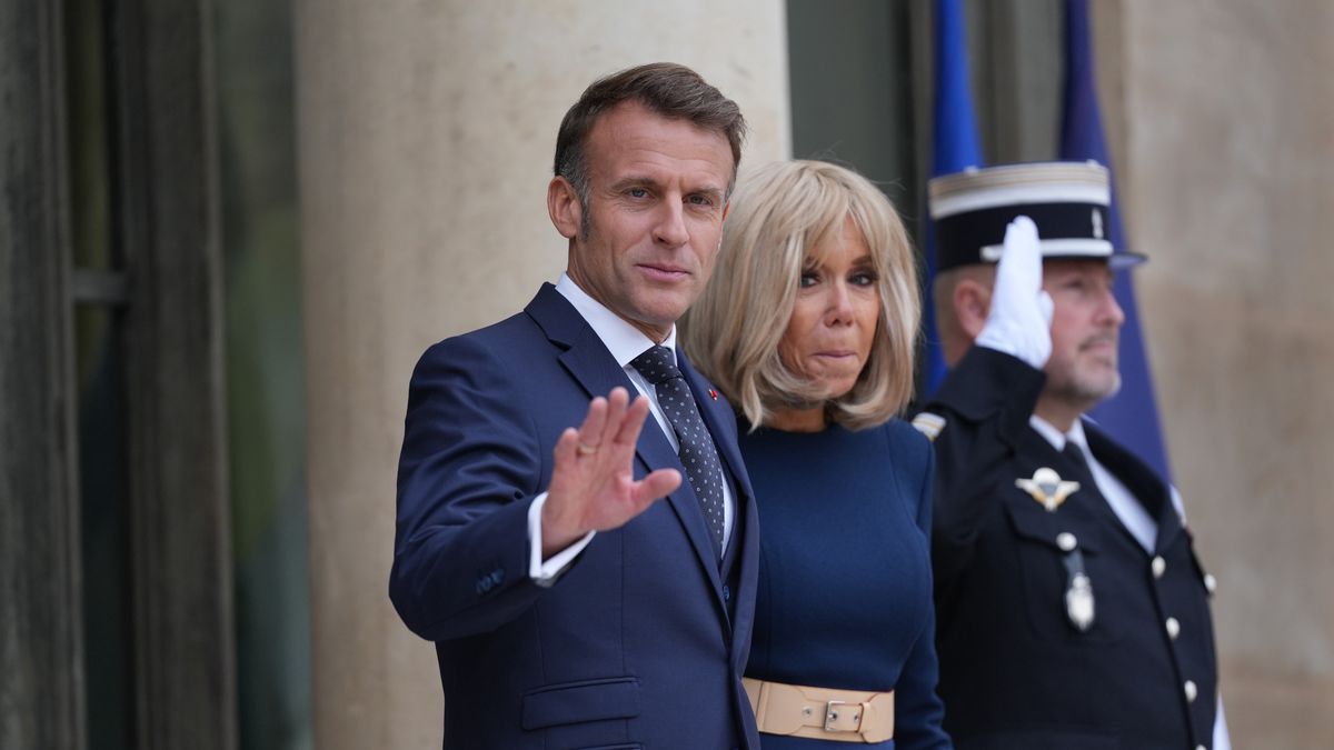 Emmanuel Macron, France's president, left, and Brigitte Macron, France's first lady, at the Elysee Palace in Paris, France, on Wednesday, Oct. 8, 2025. Macron's allies opened the door to suspending his contested pension reform as the French president strains to find an accord that would allow a new government to be formed. Photographer: Nathan Laine/Bloomberg via Getty Images