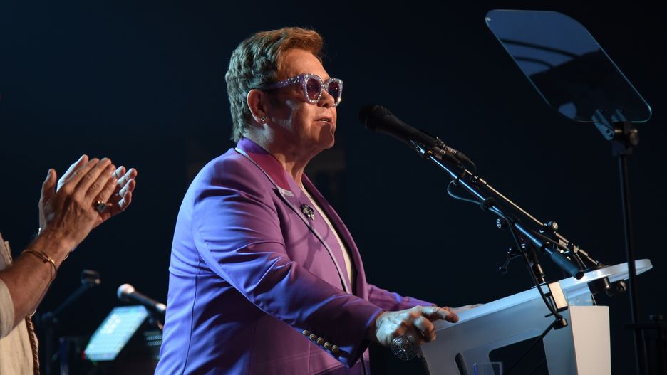 ANTIBES, FRANCE - JULY 24:  David Furnish and Elton John speak on stage during the first “Midsummer Party” hosted by Elton John and David Furnish to raise funds for the Elton John Aids Foundation at the Villa Dorane on July 24, 2019 in Antibes, France. (Photo by Gareth Cattermole/Getty Images for EJAF)