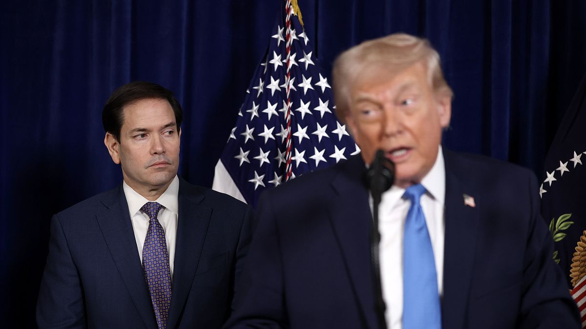 PALM BEACH, FLORIDA - JANUARY 03: U.S. Secretary of State Marco Rubio listens as U.S. President Donald Trump addresses the media during a news conference at his Mar-a-Lago club on January 03, 2026, in Palm Beach, Florida. President Trump confirmed that the U.S. military carried out a large-scale strike in Caracas overnight, resulting in the capture of Venezuelan leader Nicolas Maduro and his wife, Cilia Flores.  (Photo by Joe Raedle/Getty Images)