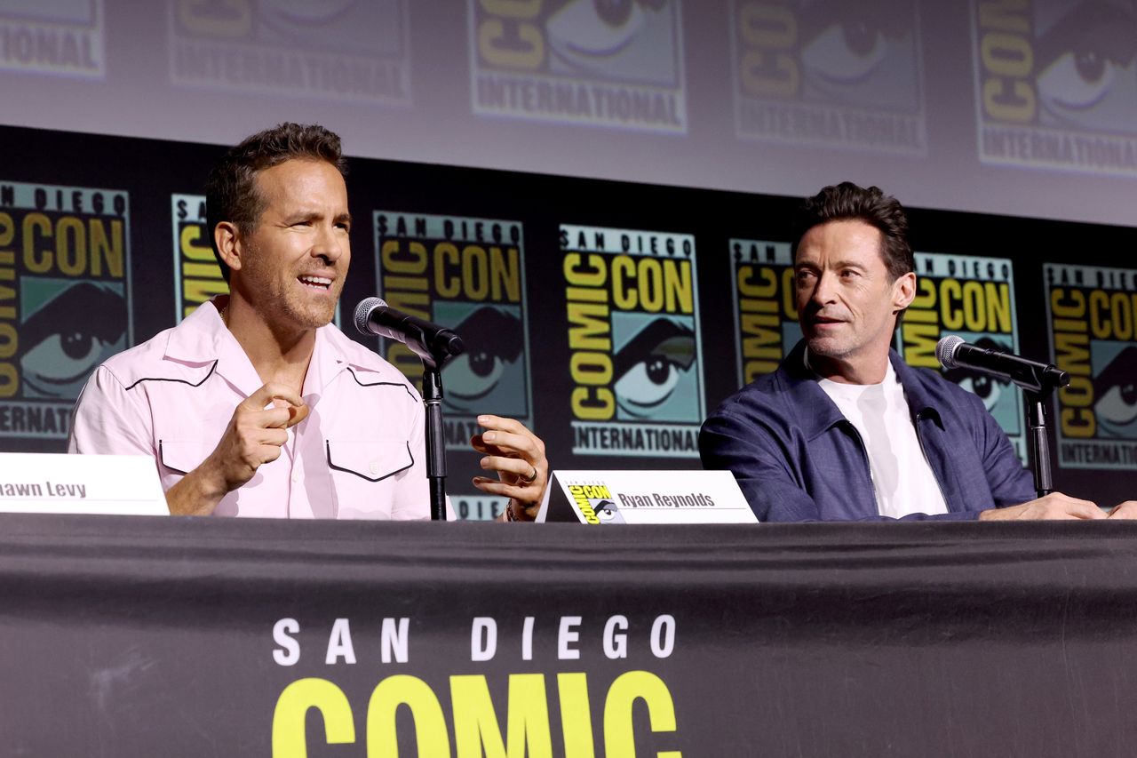 SAN DIEGO, CALIFORNIA - JULY 25: (L-R) Ryan Reynolds and Hugh Jackman speak onstage during Marvel Studios: The Ultimate Deadpool & Wolverine Celebration of Life in Hall H at SDCC in San Diego, California on July 25, 2024. (Photo by Jesse Grant/Getty Images for Disney)