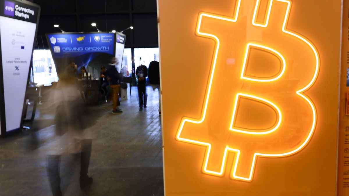 The Bitcoin symbol, the largest cryptocurrency by market cap that operates free of any central control and that relies on a peer-to-peer software and cryptography, on a luminous banner on the BitBase stand during the Mobile World Congress 2023 on March 10, 2023, in Barcelona, Spain. (Photo by Joan Cros/NurPhoto via Getty Images)