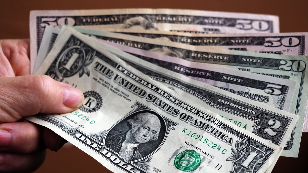 UKRAINE - 2020/10/08: In this photo illustration a 1 dollar bill with various dollar bills. (Photo Illustration by Igor Golovniov/SOPA Images/LightRocket via Getty Images)