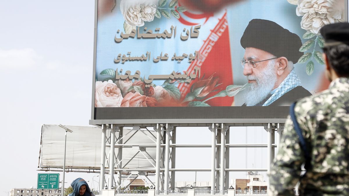 SANA'A, YEMEN - APRIL 3: Yemen's Houthi supporters walk next to a billboard depicting the Iranian Supreme Leader Ali Hosseini Khamenei, during a demonstration staged to show solidarity with Iran on April 3, 2026 in Sana'a, Yemen. Yemen's Iran-backed armed Houthi group has warned they will move to shutter the Bab Al-Mandeb Strait through missile-drone attacks if Gulf nations join the US-Israel war on Iran. (Photo by Mohammed Hamoud/Getty Images)