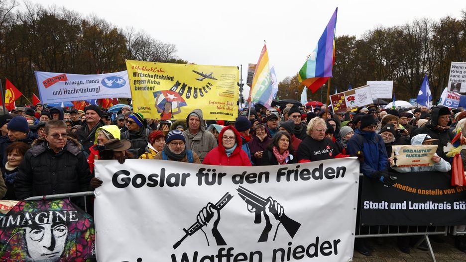BERLIN, GERMANY - NOVEMBER 25: Protestors hold placard with peace slogans at a peace protest on November 25, 2023 in Berlin, Germany. The protest under the motto: "Never Again War - Down With The Weapons!" is taking place as Israeli and Hamas forces are maintaining a temporary ceasefire to allow the release of some hostages from Gaza and Russia's war in Ukraine continues to rage. (Photo by Michele Tantussi/Getty Images)