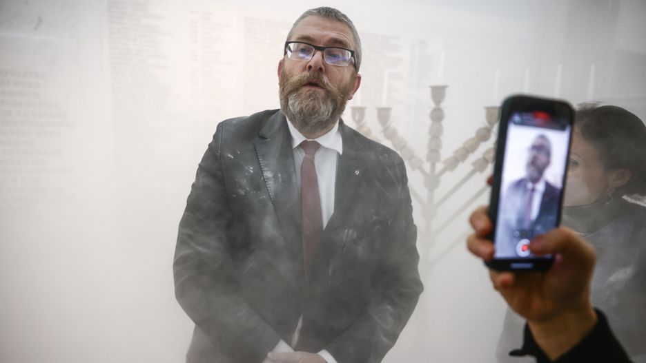 Grzegorz Braun, a member of the far-right Confederation party is seen after using a fire extinguisher on to put out candles on a menorah that was lit during Hannukah celebration in the parliament building in Warsaw, Poland on December 12, 2023.  (Photo by Beata Zawrzel/NurPhoto via Getty Images)