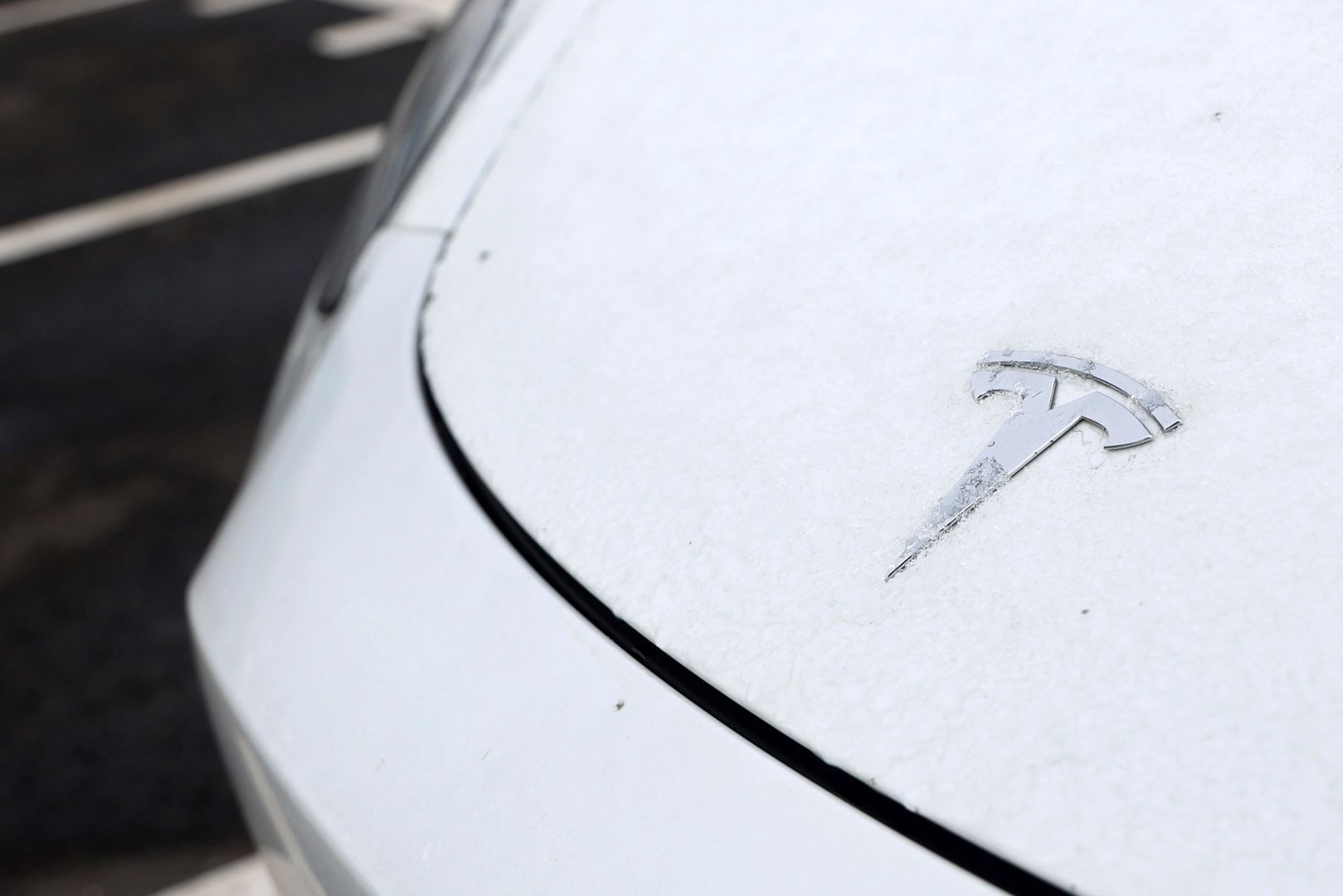 Frost on the badge of a Tesla Model Y electric vehicle in a lot at the Tesla Inc. Gigafactory in Gruenheide, Germany, on Saturday, Jan. 21, 2023. Tesla CEO Elon Musk played down how much impact his tweets have on the company's stock price as he defended himself at a trial in San Francisco federal court on Friday over his 2018 tweet about taking the electric car-maker private. Photographer: Liesa Johannssen/Bloomberg via Getty Images