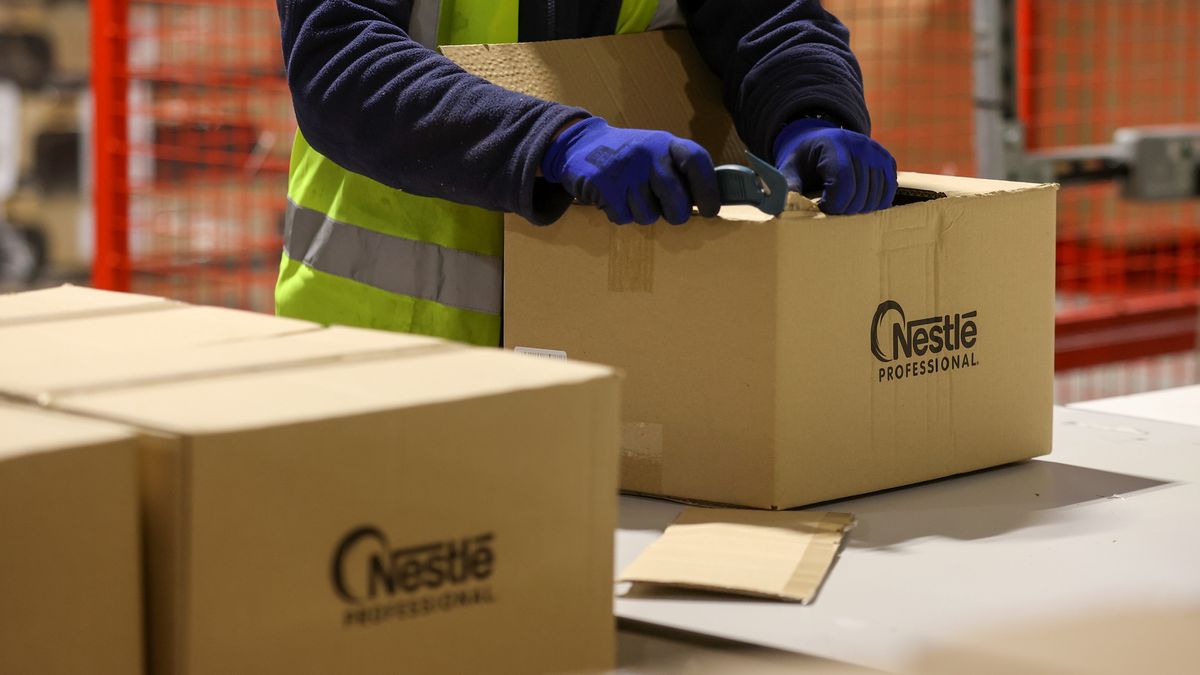 An employee packs products manufactured by Nestle SA, at a distribution warehouse operated by GXO Logistics Inc. near Derby, U.K., on Friday, Dec. 10, 2021. British logistics companies are taking steps to boost training, recruitment and pay, "yet there remains concern that some supply chain disruption will continue in 2022 until these crucial roles are filled across the industry," a report by trade organization Logistics UK warned. Photographer: Chris Ratcliffe/Bloomberg via Getty Images