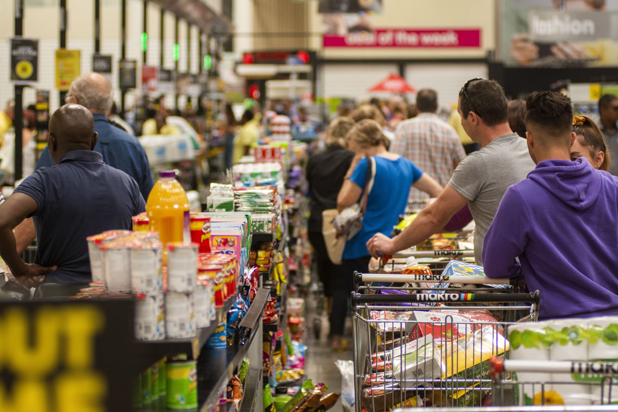 Shoppers wait in long queues at the check-out aisle inside a Makro wholesale store, operated by Masstores (Pty) Ltd., in Pretoria, South Africa, on Monday, March 16, 2020. South Africa declared a national state of disaster, halted inbound flights from countries worst affected by the coronavirus, shut schools and banned public gatherings of more than 100 people in a bid to contain the spread of the disease. Photographer: Waldo Swiegers/Bloomberg via Getty Images