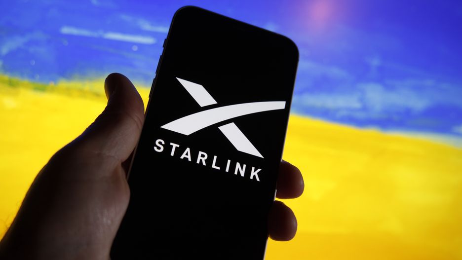 The Starlink logo is seen on a mobile device with a Ukrainian flag in the background in this illustration photo in Warsaw, Poland on 21 September, 2022. Starlink owner and founder Elon Musk Starlink owner Elon Musk has decided to have the satellite company resume internet services in Ukraine after complaints of Starlink owner Elon Musk has decided to have the satellite company resume internet services in Ukraine after complaints of substantial costs. The satellite service, provided for free, is essential to the armed forces of Ukraine batteling Russian forces. (Photo by STR/NurPhoto via Getty Images)