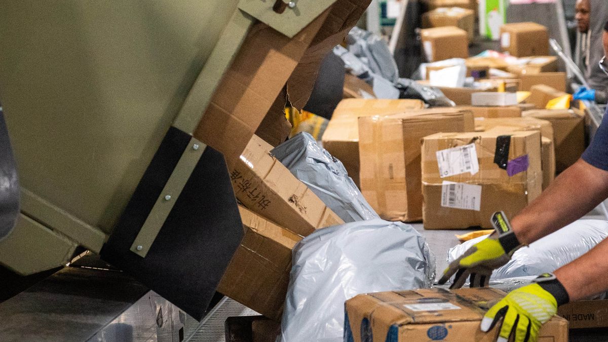 A worker sorts packages during the holiday shipping season at the United States Postal Service (USPS) Los Angeles Mail Processing & Distribution Center in Los Angeles, California, US, on Saturday, Dec. 21, 2024. The Federal Reserve's preferred measure of underlying inflation showed spending advanced 0.3%, indicating consumer resilience during the critical holiday shopping season. Photographer: Kyle Grillot/Bloomberg via Getty Images