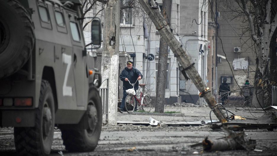 TemporaryA man walks with a bicycle in central Mariupol on April 12, 2022, as Russian troops intensify a campaign to take the strategic port city, part of an anticipated massive onslaught across eastern Ukraine, while Russia's President makes a defiant case for the war on Russia's neighbour. - *EDITOR'S NOTE: This picture was taken during a trip organized by the Russian military.* (Photo by Alexander NEMENOV / AFP)ALEXANDER NEMENOV