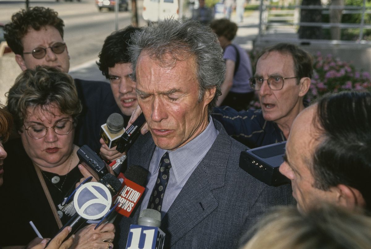 American actor and film director Clint Eastwood is surrounded by the press, who interview him following the fraud suit brought by his former partner, Sondra Locke, at Burbank Superior Court in Burbank, California, 17th September 1996. Sondra Locke received an out-of-court settlement after contending Eastwood had sabotaged her career. (Photo by Vinnie Zuffante/Getty Images)