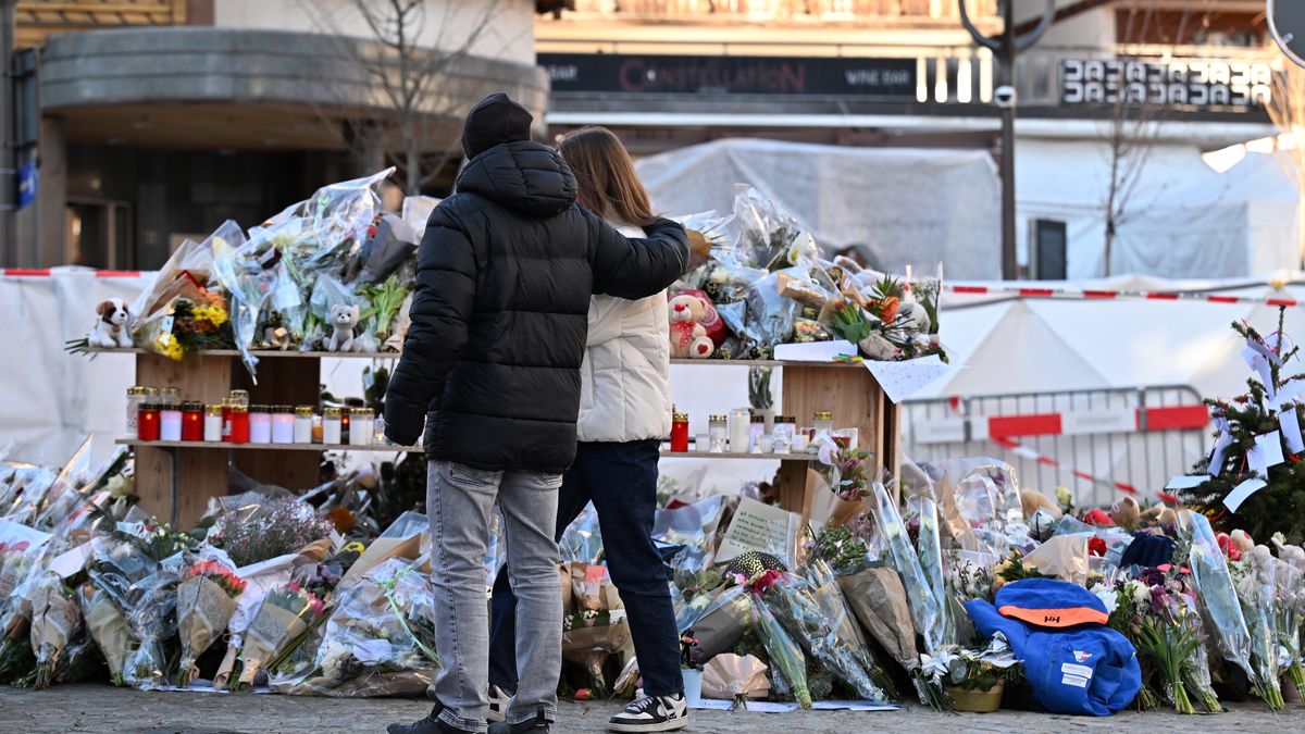CRANS-MONTANA, SWITZERLAND - JANUARY 03: Flowers and candles are laid in front of the disaster site on January 03, 2026 as the investigation continues into the deadly New Year's Eve fire at Le Constellation bar in Crans-Montana, Switzerland. Swiss authorities said in a press conference on Jan. 2 that they are still working to identify all the victims of the fire, which killed around 40 people and injured over 100 others. (Photo by Harold Cunningham/Getty Images)