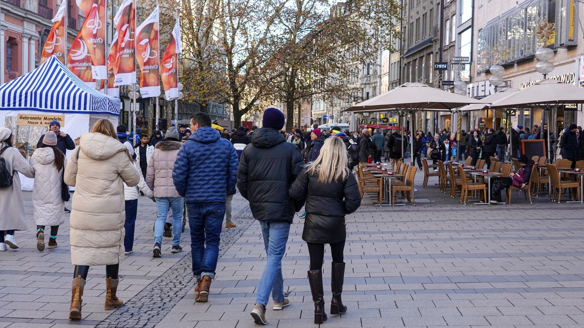 A bustling shopping street in Munich, Bavaria, Germany, on November 30, 2024, is alive with the festive spirit as shoppers fill the streets, admire holiday decorations, and select Christmas gifts. The atmosphere is lively, with a sense of excitement for the upcoming holidays. Kaufinger Strasse in Munich is crowded as many people are out shopping for Christmas gifts. The store windows are decorated with festive displays, showcasing a wide range of gifts and holiday items. Passersby stop to admire the windows and choose presents for the upcoming holiday season. Numerous Christmas stalls in the middle of the street invite people to drink mulled wine or eat snacks. As one of Munich's central shopping streets, Kaufinger Strasse attracts both locals and tourists who are completing their pre-Christmas shopping. The festive atmosphere is enhanced by the Christmas decorations and the increasing number of shoppers in the stores. The street becomes a lively spot for those looking to buy gifts and experience the holiday spirit. (Photo by Michael Nguyen/NurPhoto via Getty Images)