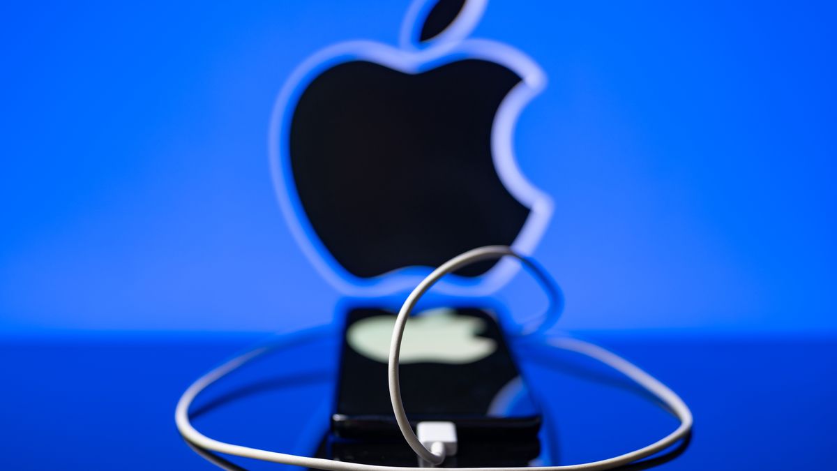 Apple logo displayed on a smartphone with USB -C cable with Apple seen in the backgroundon september 17, 2023, in Brussels, Belgium.(Photo Illustration  by Jonathan Raa/NurPhoto via Getty Images)