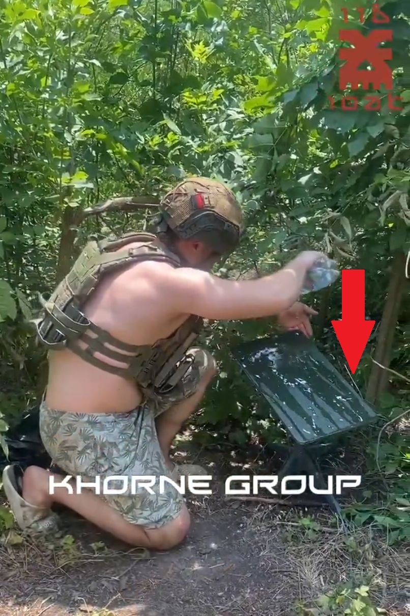 A Ukrainian soldier cooling the Starlink system antenna with water.