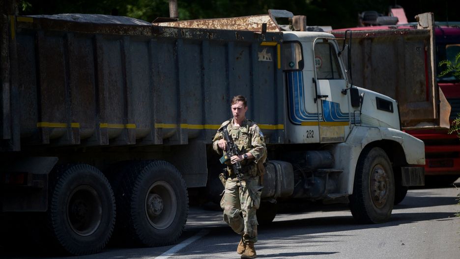 Patrol żołnierzy NATO przy barykadzie, wzniesionej przez kosowskich Serbów, na przejściu granicznym w     