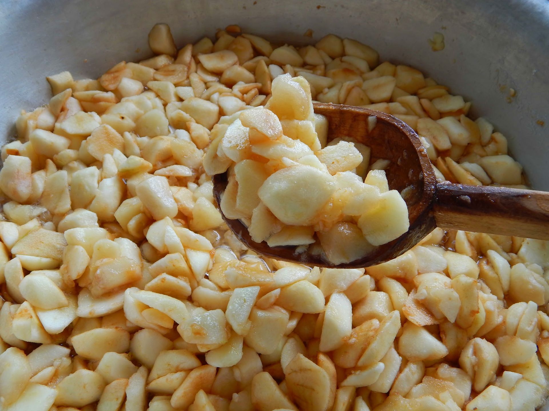 apples sliced in slices with squares in a wooden spoon, apple jam is brewed
apples sliced in slices with squares in a wooden spoon, apple jam is brewed.