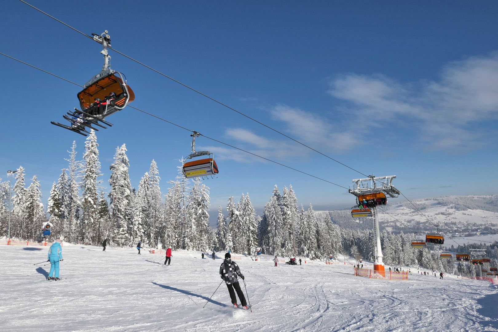 Bialka Tatrzanska, Poland - January 11, 2019: Skiers ski on the ski slope in popular winter resort Kotelnica Bialczanska.bialka tatrzanska, winter, outdoor, hill, polish, natural,  whit, poland, ski slope, ski, winter, bialka tatrzanska, outdoor, hill, polish, natural, white, tatra, slope, season, recreation, blue, weather, mountain, sky, resort, snow, nature, sport, landscape, january, snowy, skiers, travel, cold, tourism, scenic, tourists, ski lift, lift, kotelnica, seasonal, chair, tracks, piste, run, people, trees
