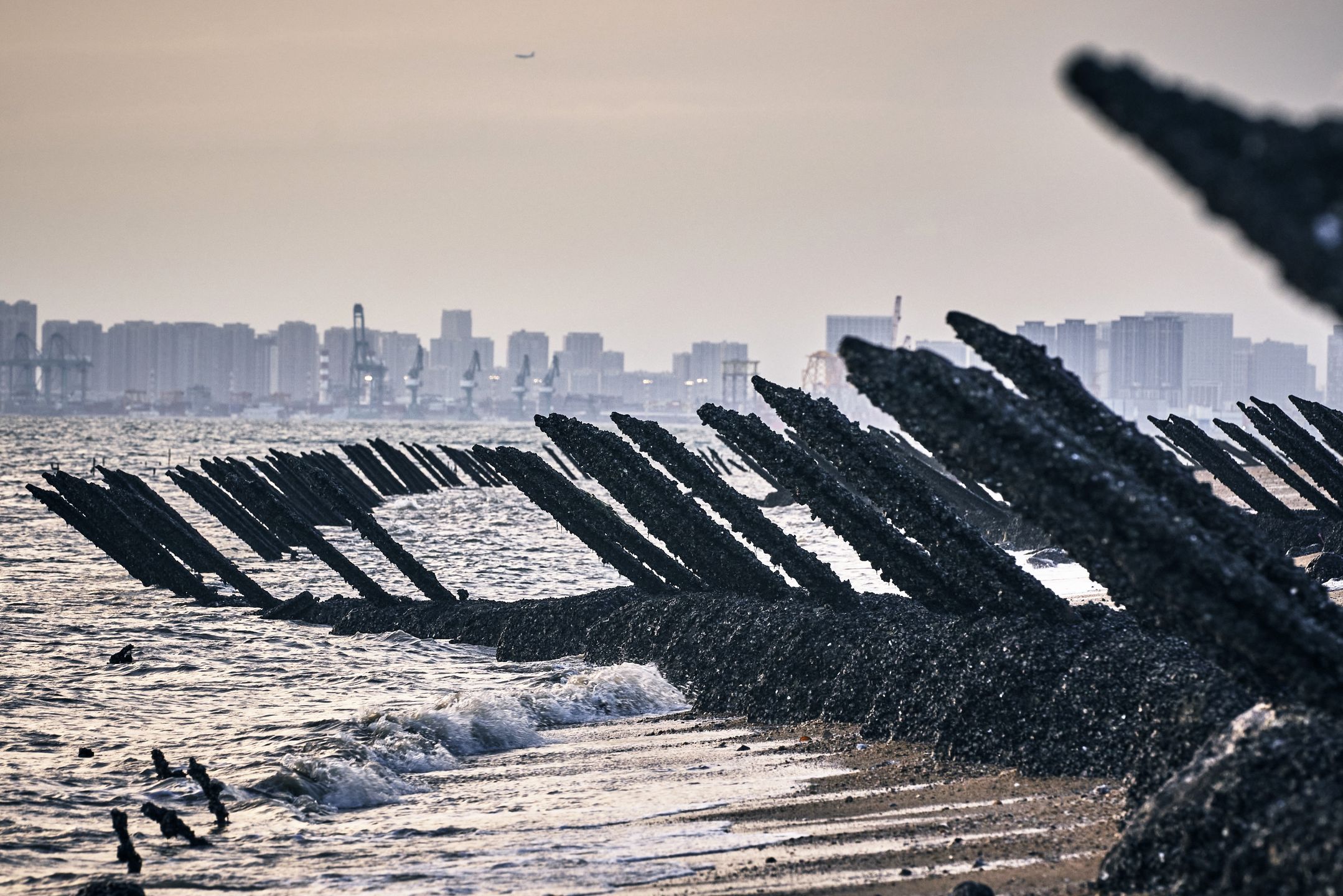 General Views of Taiwan's Offshore Outpost Kinmen IslandBuildings in Xiamen on mainland China stand across the Taiwan Strait from anti-landing barriers on a beach in Kinmen, Taiwan, on Monday, Aug. 21, 2023. Kinmen is located just off mainland China and was once the site of fierce fighting. Photographer: An Rong Xu/Bloomberg via Getty ImagesBloombergTaiwanese, Spikes, Defense, cityscape, skyscrapers, Fortification, Defence, Military, Buildings, East Asian, skyline, Urban Scene, Kinmen Island, Asia, Government, Taiwan, Politics