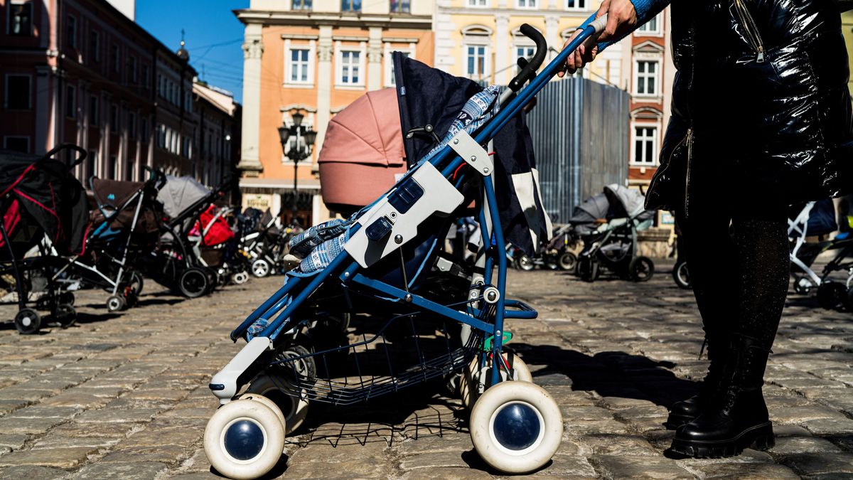 LVIV, UKRAINE - 2022/03/18: A woman seen with a stroller in Rynok Square during the memorial. 109 strollers have been arranged in several rows in Rynok Square in memory and honour of the 109 children killed by the war in Ukraine up to date. (Photo by Vincenzo Circosta/SOPA Images/LightRocket via Getty Images)